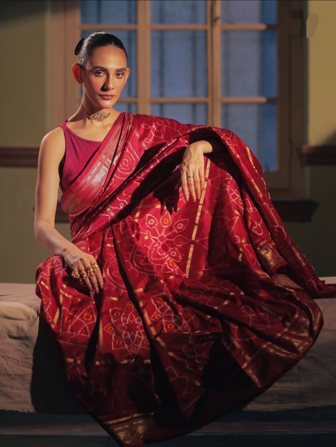 Bandhani-inspired handwoven saree in deep red and gold